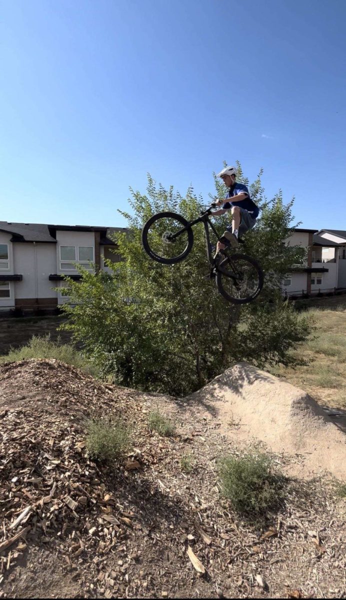Mountain Biking season is in full swing. Sophomore Lucas Reese hits a jump at the Eagle Bike Park for practice. 