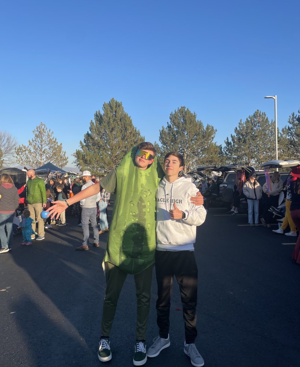 Sophomores Lincoln Swenson (Left) and Graham Patterson (Right) stand in the middle of cars lined up for the Trunk-O-Treat. The event was a huge success. 
