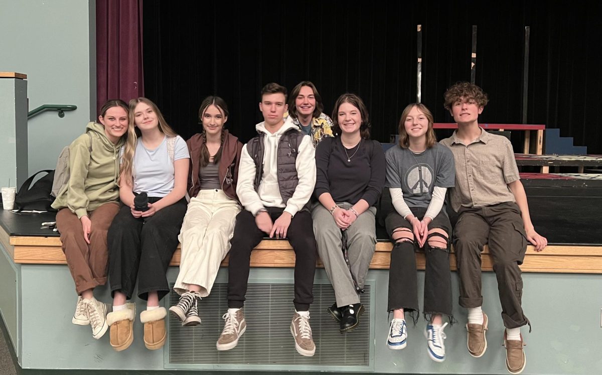 The Yellow Boat cast sit on the Eagle High stage for a cast photo after a successful day of rehearsing their upcoming play. Cast from left to right: Junior Marin Weaver, sophomore Ally Godfrey, sophomore Taylor Milliot, senior Jack Windsor, senior Bradley Fischer, junior Lauren Avery, freshman Katiana Lovitt and junior Cole McAdams.