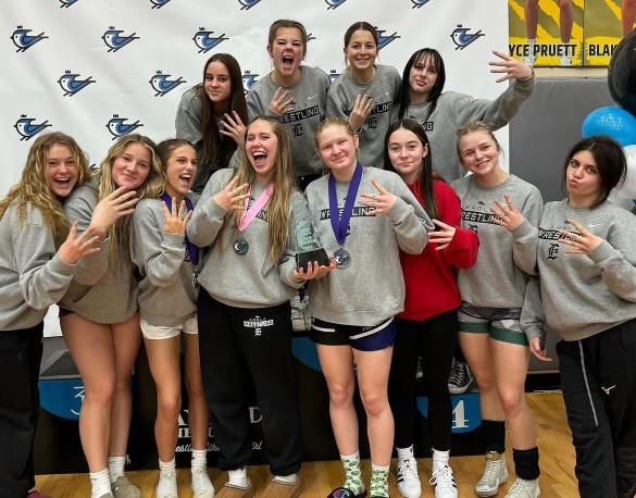 The girls’ wrestling team poses for a picture after placing fourth in the JayBird meet. Seniors Paige Cantwell, Jordynn LeBeau and Eden Flake prepare for their last high school meets at District and State championships the following weeks.