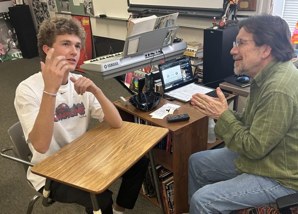 Senior Parker Shipp receives advice from teacher Mike Corbett. Corbett gives advice to his senior students on life after high school. 