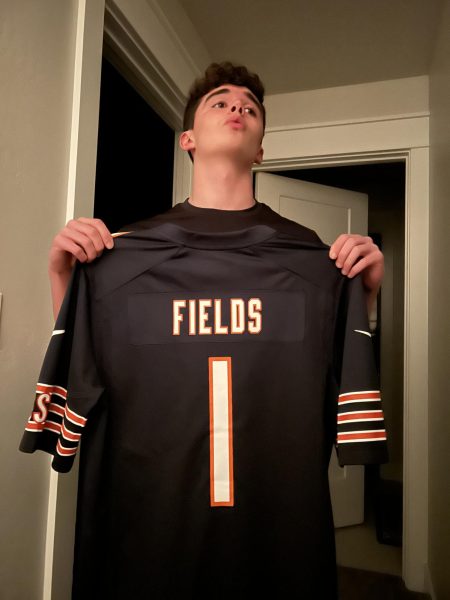 Junior Ryan Colvin holds up a Justin Fields Chicago Bears jersey. Colvin is a big fan of the Chicago Bears.
