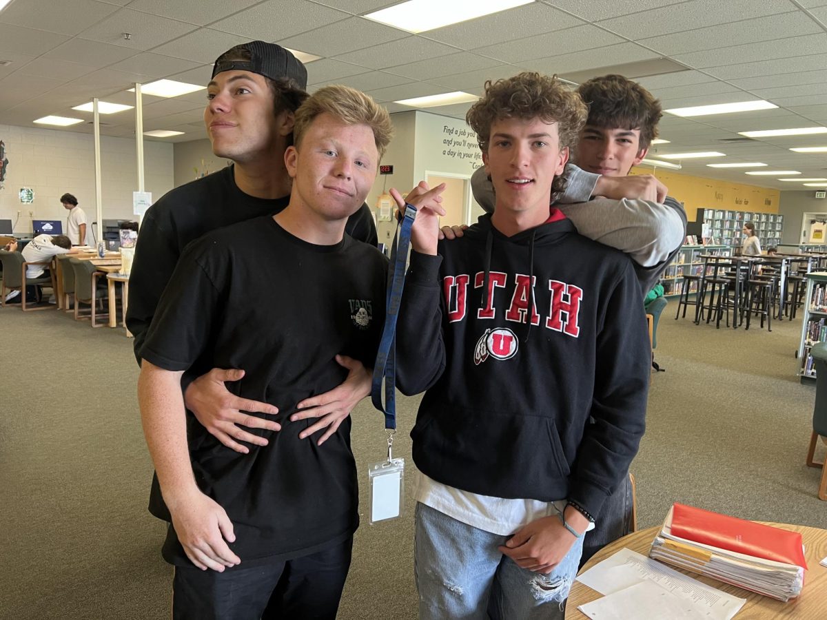 Seniors Jimmy Flynn, Revan Perry, Caden Chandler and Jacob Black display an Eagle High library hall pass. Administration’s new hallway policies have recently limited usage of hall passes, making the process of exiting the classroom more difficult for students. 