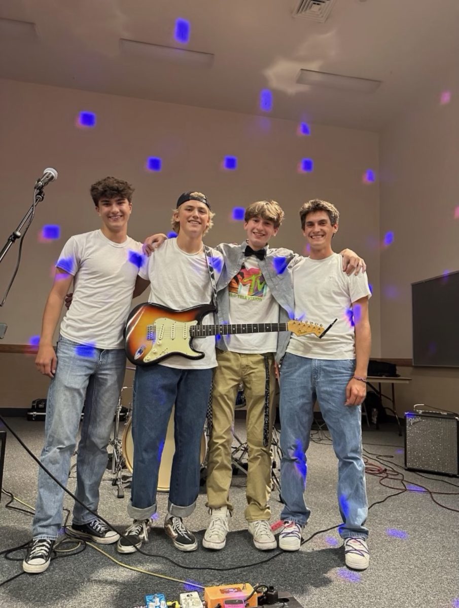 Senior Brayden Aurich, senior Jack Gochnour, junior Noah White and senior Grant Glenn practice their songs and performances at a church building. They plan on performing in the Battle of the Bands again this year. 