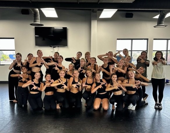 The Eagle High Lightning dance team poses for a team photo after they get new choreography for this year. The team prepares to practice their choreography to perfection.