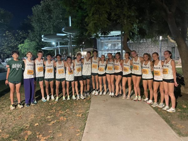 The varsity Cross Country team poses for a triumphant team photo. The runners were pushed to their limits, but managed to swiftly cross the finish line.