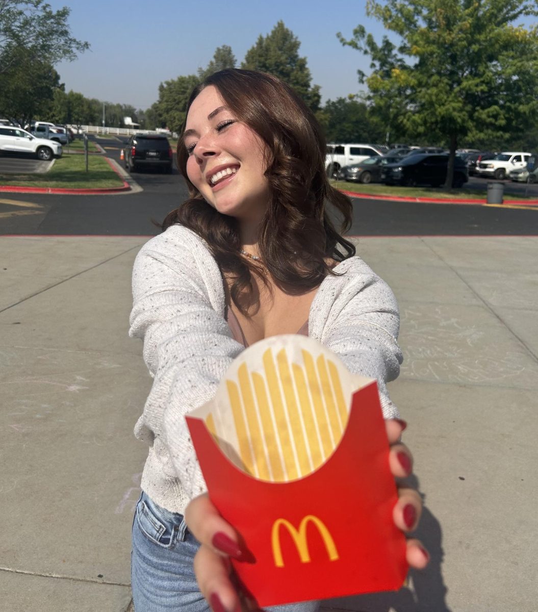 Sophomore Lucy Holmes shows off her lunch on a warm Friday afternoon. Choosing a large french fry and a soda.