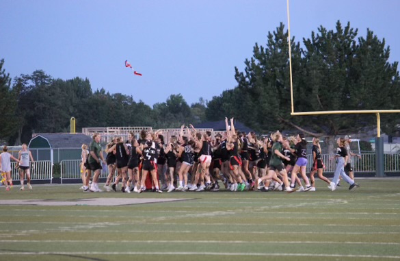 The senior powderpuff team celebrates after they beat the sophomores in the Powderpuff Championship. They win their third championship in a row, after beating their opponents in their sophomore and junior years.