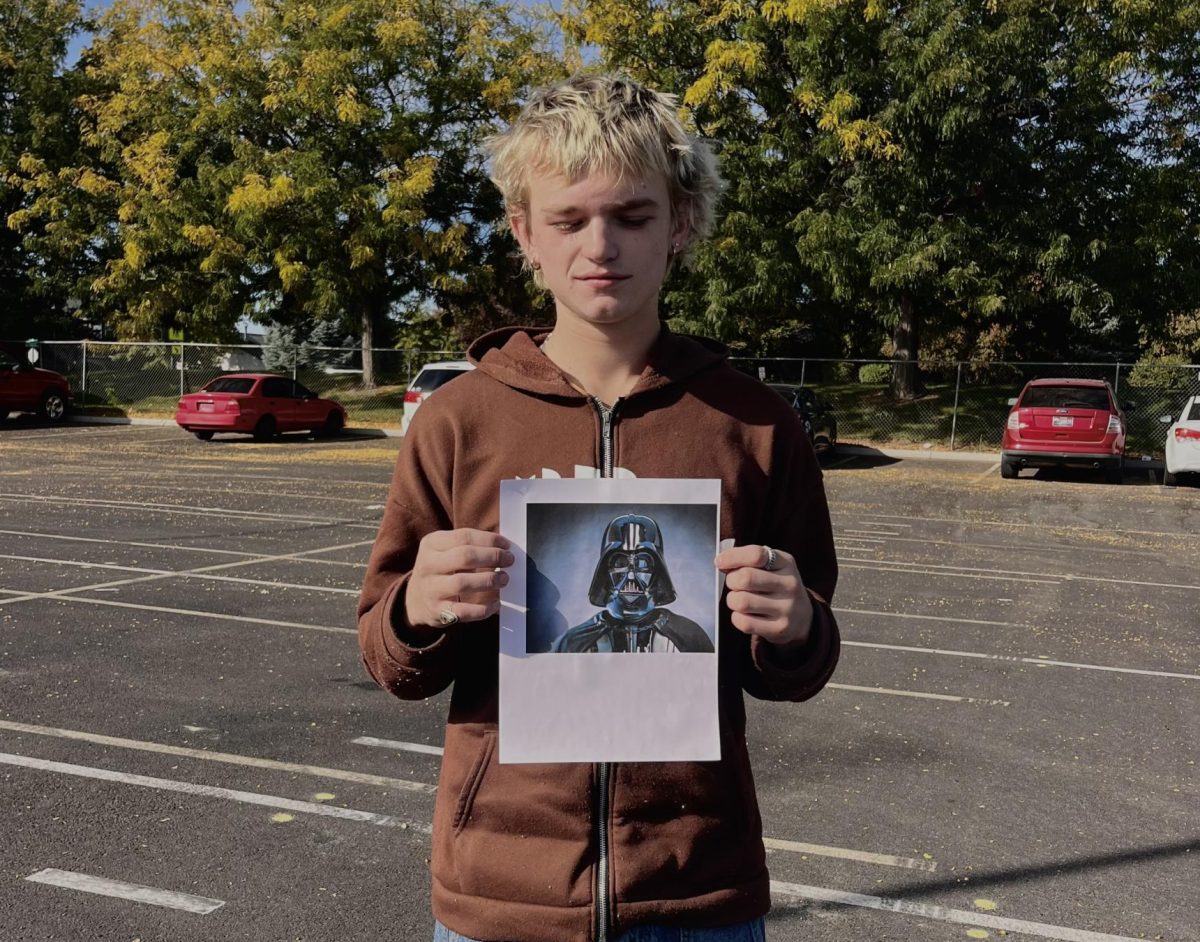 Sophomore Zane Sparks holds a photo of Darth Vader. The late James Earl Jones was most famously known for being the voice of Darth Vadar. 