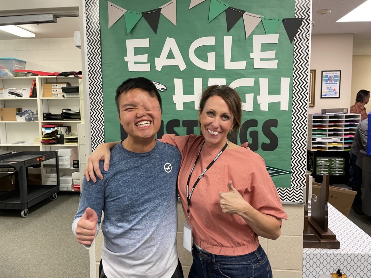 Senior Jimmy Larsen and secretary Rachel Mcewen stand in the front office of Eagle High. The two work closely together throughout the school year. 