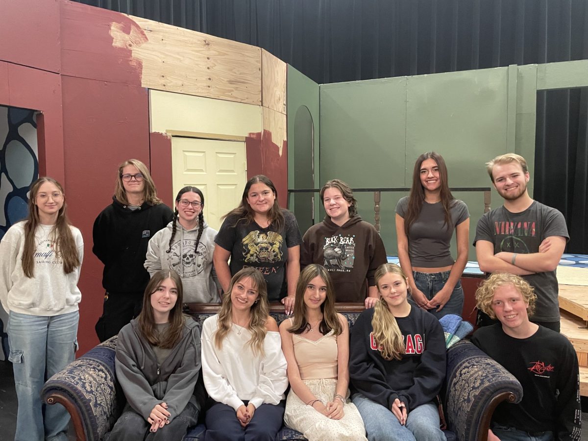 Junior Brooklyn Seymour (Props), senior Bryan Vandagriff (Light), senior Rachel Nahmias (Sound), senior Carina Teebken (Stage Manager), sophomore Lily Towne (Assistant. Stag manager), and cast members senior Lauren Avery, junior Allyson Godfrey, senior Mack Harvey, junior Taylor Milliot, senior Jacey Ulrich, senior Marin Weaver and senior Henry Wright are on their set for the upcoming play. They are very excited for their upcoming play, “The Game’s Afoot”. 