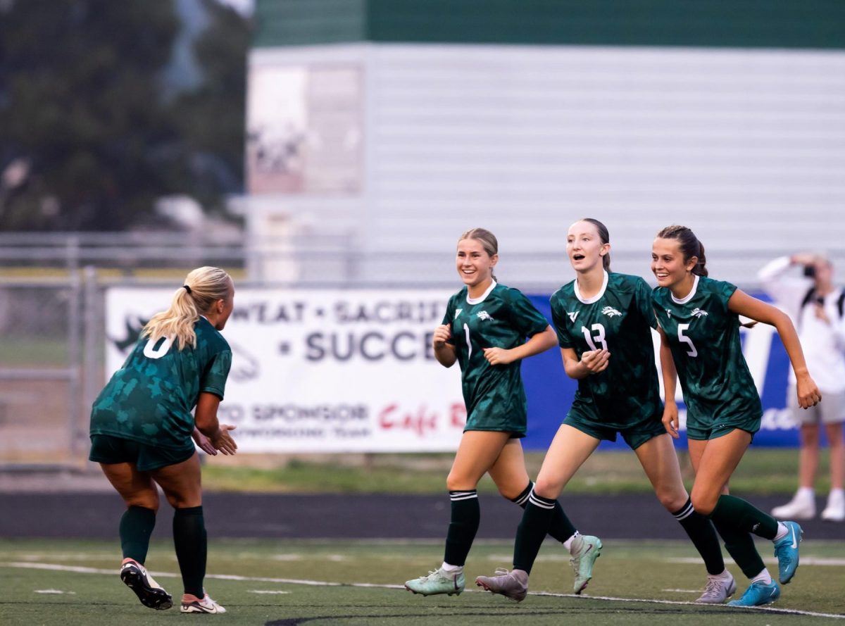 Junior Forward Rebecca Gabriele scores a goal against Capital High. Gabriele celebrates her goal with her teammates.