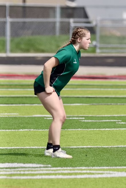 Junior Taylor Ray is focused on scoring at the girls rugby game. She is striving to get a point with a tackle. 