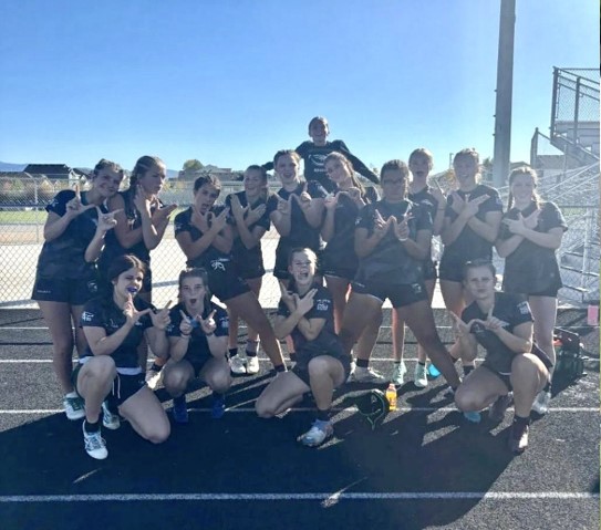 The rugby girls hold up a "W" for the wins and wild times. This season was a celebration of teamwork, grit and fun for the rugby girls this season. 