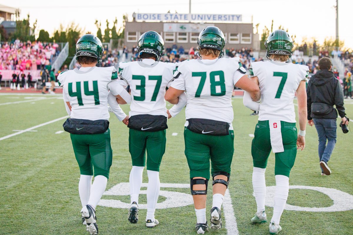 Junior Jaxson Lebeau, senior Lucas Boockholdt, senior Anthony Toomey and senior Chance Jones walk out to the coin flip for their final regular season game against Borah High. Eagle High won the game with a final score of 35-22. 