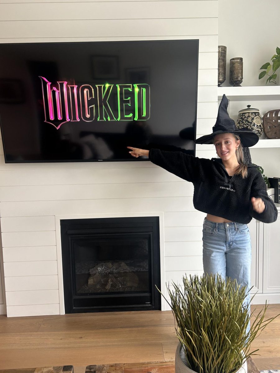 Junior Emma Stevens shows off her costume for the Wicked Premier, as she is a fan of the musical. She plans to watch a fun makeup routine for the premiere to get into the spirit of the movie. 