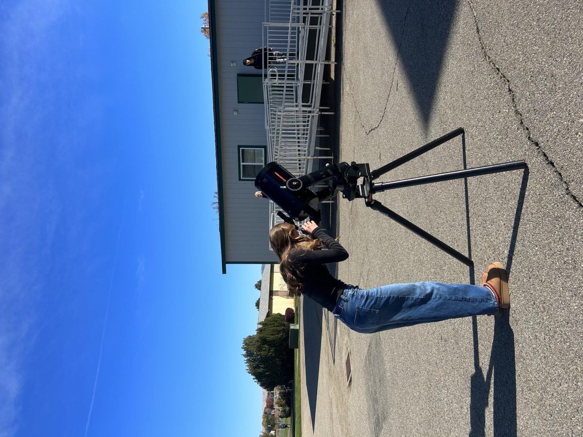 Junior Rebecca Gabriel uses a telescope to look at the stars, planets and other space related things such as the Europa Mission. This mission is aimed to investigate Jupiter and search for signs of extraterrestrial life. 