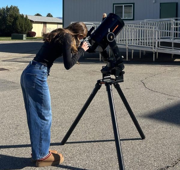 Junior Rebecca Gabriel uses a telescope to look at the stars, planets and other space related things such as the Europa Mission. This mission is aimed to investigate Jupiter and search for signs of extraterrestrial life. 