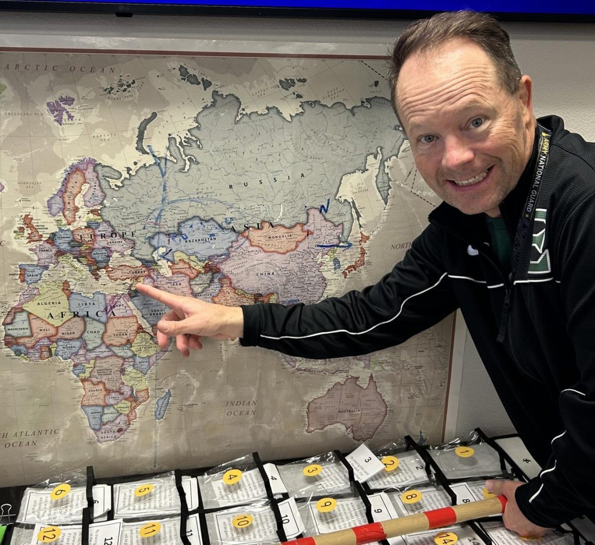 Eagle High teacher Stephen Pratt shows Israel on a classroom map. He points to the center spot of conflict in the Israel and Hamas war.