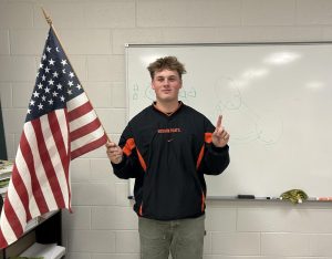 Election Opinion by Chance Jones: Senior Cole Brooks holds the American Flag after the 2024 election. Brooks took part in the democratic process by voting for government officials. 