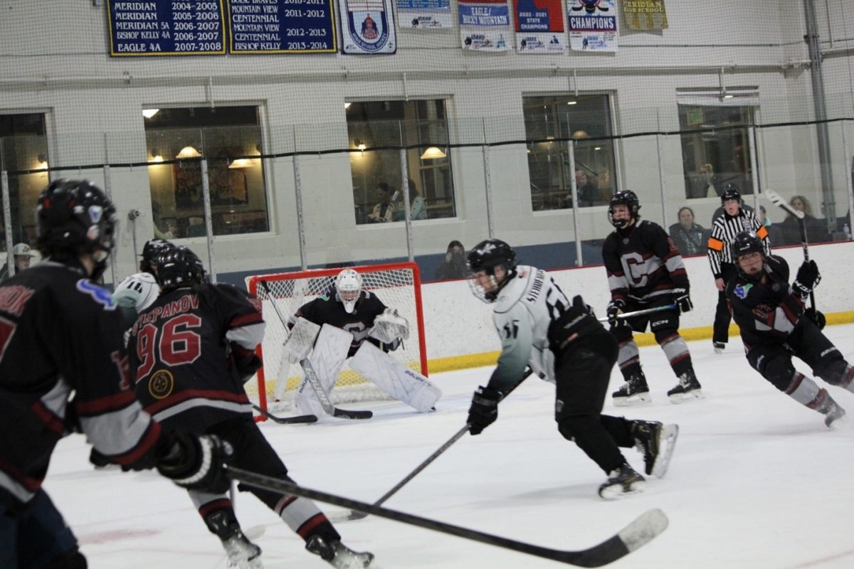 Junior Enzo Stehrenberger glides on the ice at a tightly contested hockey game. He plays against a Mountain View High and Centennial High combined hockey team. 