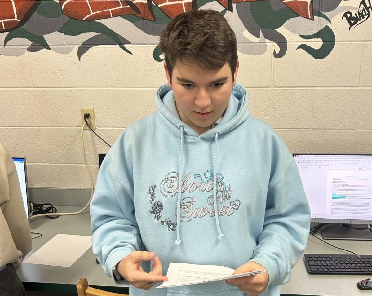 Junior Phil Cooley reads a list of slang words. He is surprised as he figures out a few words he has never really understood. 