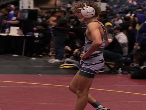 Junior Dylan Frothinger walks onto the mat ready for his competition at Meridian High. Athletes are excited for the season that recently commenced. 