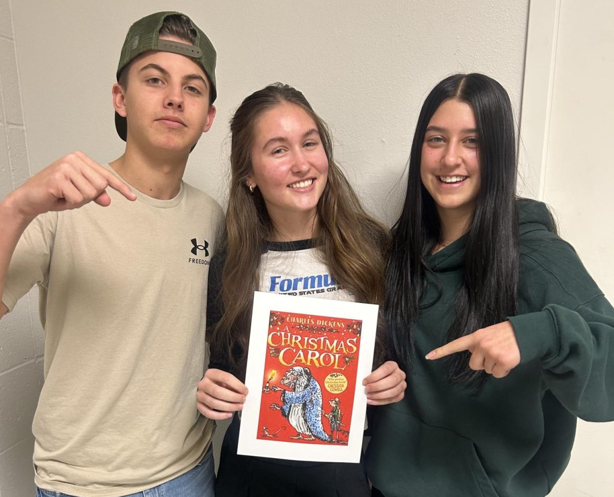 Junior Noah Gingham (left), junior Rachel McClaren (middle) and junior Alaina Tiner (right), all enjoyed reading “A Christmas Carol” by Charles Dickens. This is a popular Christmas-themed book perfect for a day of cozy reading. 