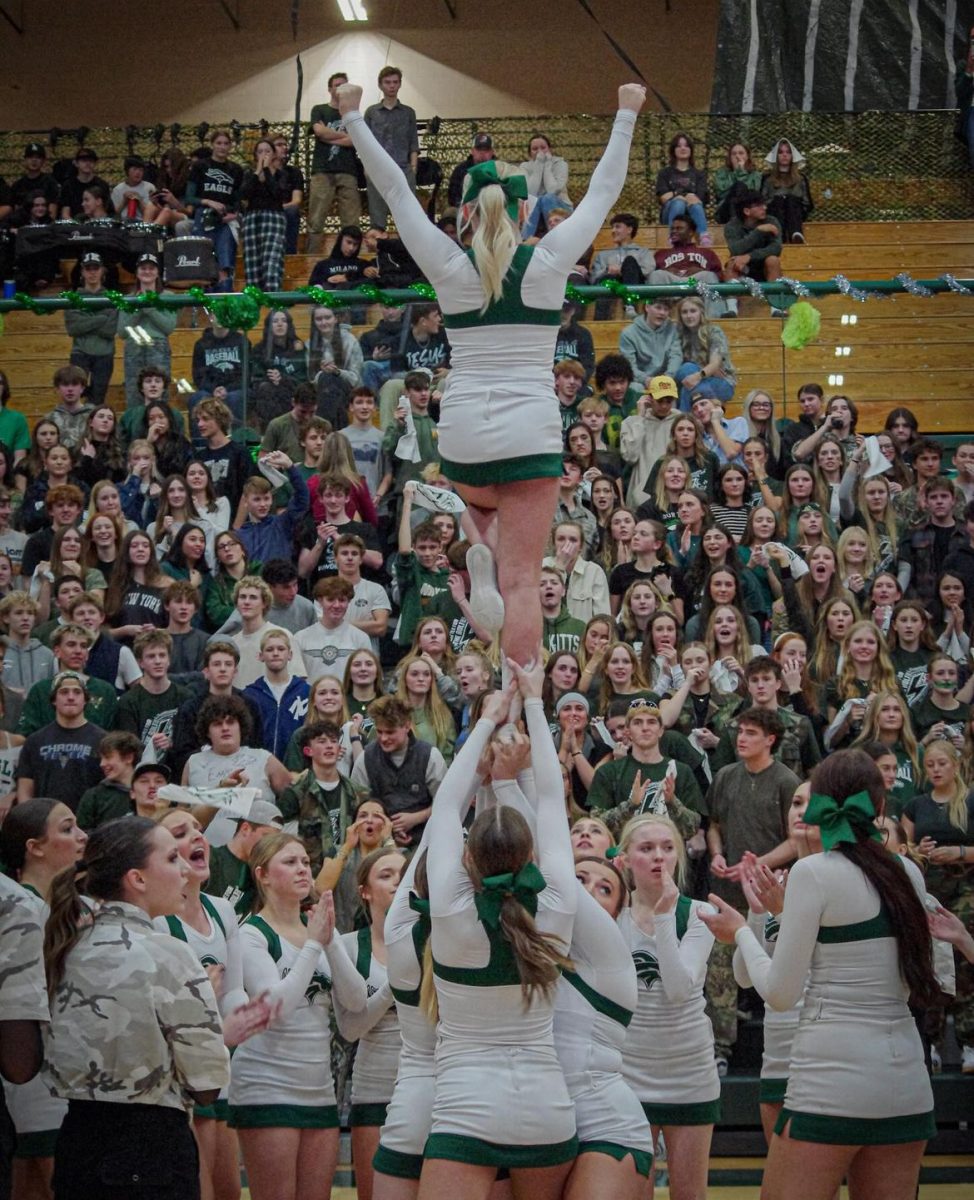 Junior Adelie Cook is held in the air by her teammates. The girls participate in The Battle of the Bolt by cheering for the Eagle High basketball players. 