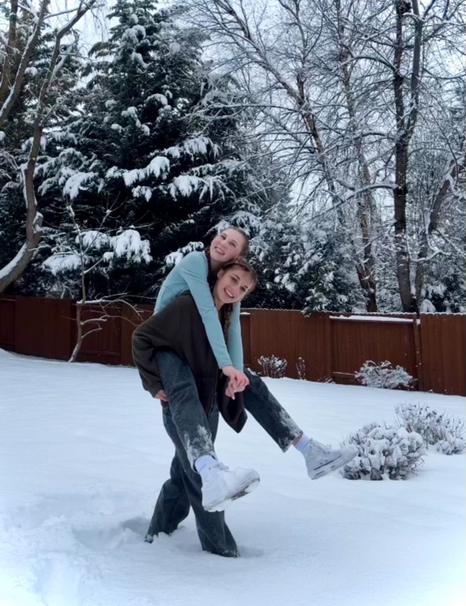 Junior Lola Kristine and sophomore Sophia Hill both love it when school is canceled due to snow. They spend quality time together enjoying the outdoors.