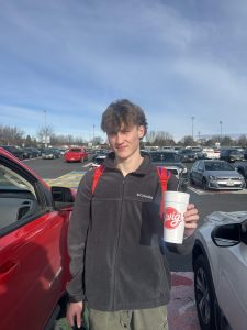 Senior Clark Kochivar holds his favorite Swig drink in the Eagle High parking lot. Kochivar often gets his drink at lunch. 