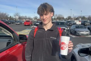 Senior Clark Kochivar holds his favorite Swig drink in the Eagle High parking lot. Kochivar often gets his drink at lunch. 