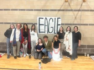 The Eagle High Drama Department stands in front of a sign representing Eagle High. After a long day of competing at Mountain View High during Districts, the students pose proudly as they await their trip to Twin Falls, Idaho to compete in the State Drama Tournament for their respective categories in Humorous, Serious and Original pieces. 