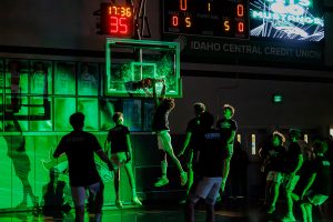 Freshman Aiden Kindrick dunks in Eagle High’s pregame routine. He is surrounded by his supportive teammates who love playing basketball. 