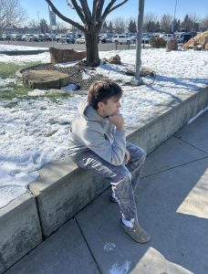 Senior Beau Sahr sits among the recent snow. He ponders on how the groundhog was correct in predicting six more weeks of winter.