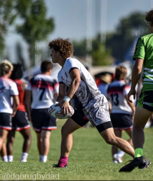 Senior Gavin Crawford, a captain and veteran of the Eagle High rugby team, gets warmed up for at the NAIs. Crawford is committed to play rugby at Central Washington University.