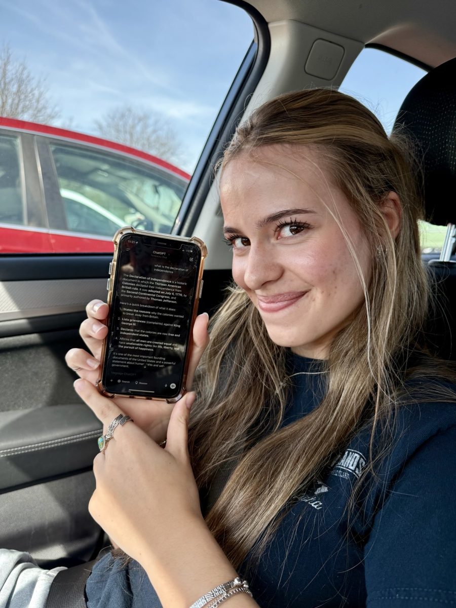 Sophomore Savannah Loftus holds up her phone which shows Chat GPT. Since the pandemic in 2020, students have been using more technology in school. There is more access to technology on their laptops, and they have resources such as ChatGPT and other artificial intelligence websites. 