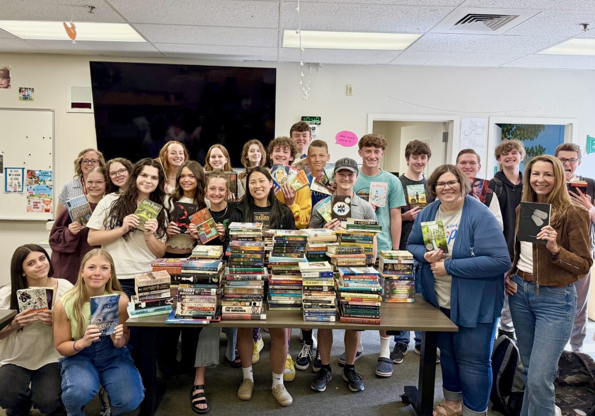 Just Serve Club helps the community by organizing a book drive. Members of this club stand with their books raised in hand. Ready to give and help to the people and readers at Eagle High and beyond. 