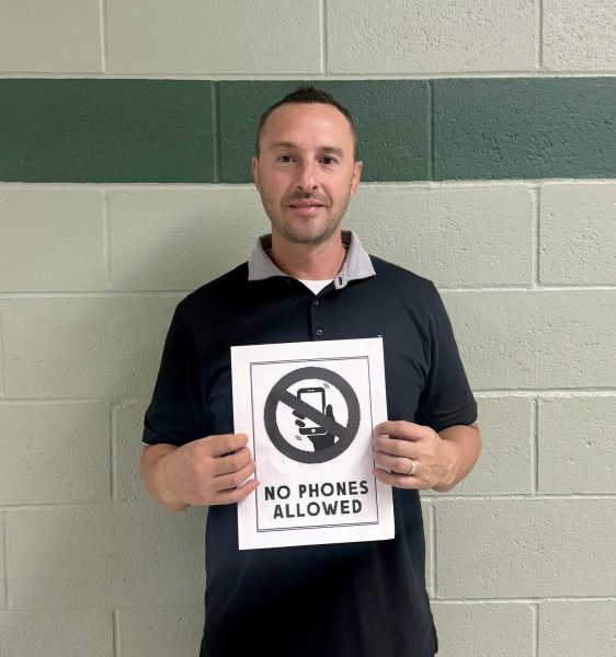 Activities director Tony Brulotte holds a sign that states no phones are allowed. In Texas, no phones are allowed on any public-school campus. This could set an example to lawmakers in Idaho to enforce this rule. 