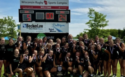 The Lady Mustangs varsity rugby team pose with their trophies after they play the winning game against Meridian High. They flew home with two national titles under their belt. 