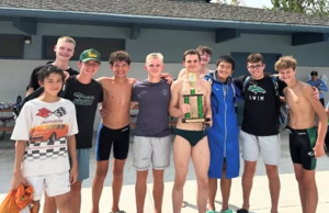 The Eagle High swim team has been working hard this season. Senior Landon Allen holds their newest trophy with several other teammates.  