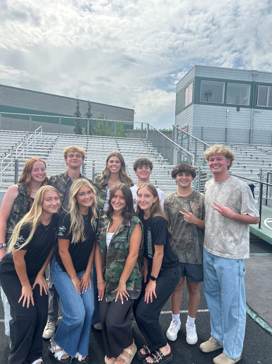 Stang Gang gets together to practice their cheers and advertise for the first football game. They pose before the Meridian High vs. Eagle High game where Eagle won 29-14. 