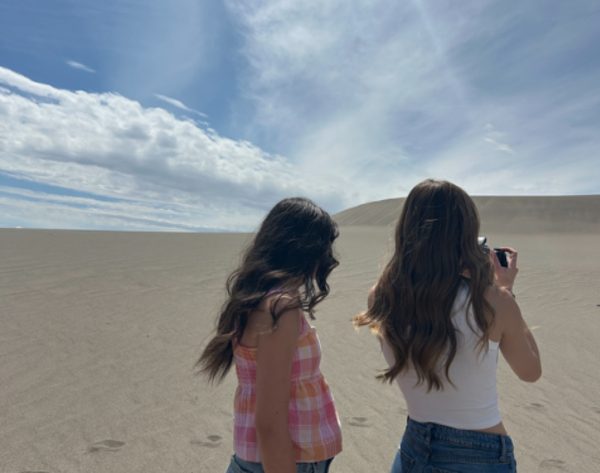 Senior Anna Glen and Senior Maddy Kotter take photos at Bruneau Dunes State Park. Going to the sand dunes during summer is a fun activity to do when the temperature isn't too high but the sun is out.
