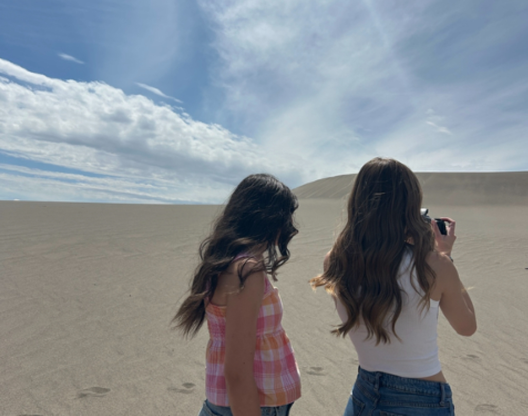Senior Anna Glen and Senior Maddy Kotter take photos at Bruneau Dunes State Park. Going to the sand dunes during summer is a fun activity to do when the temperature isn't too high but the sun is out.