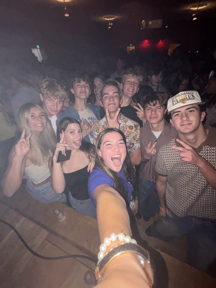 Senior Olivia Cote takes a selfie with her friends at The Shrine Social Club. A group of friends gathered to hear the band Arcy Drive play on Sept. 23. 