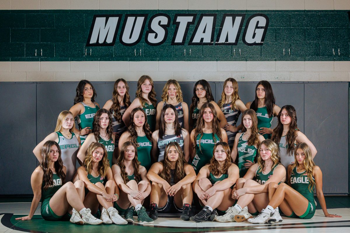 The Eagle High girl’s wrestling team poses for the flash of the camera as they prepare for a successful season. The team would later take second place at the 24-25 State tournament, making the season very successful. 