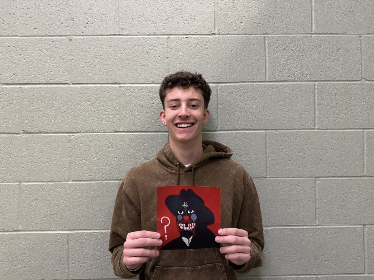 Junior Dallin Call holds the new album cover for popular rapper 21 Savage, who just released a new album. The new hit album is titled “What Happened To The Streets”.