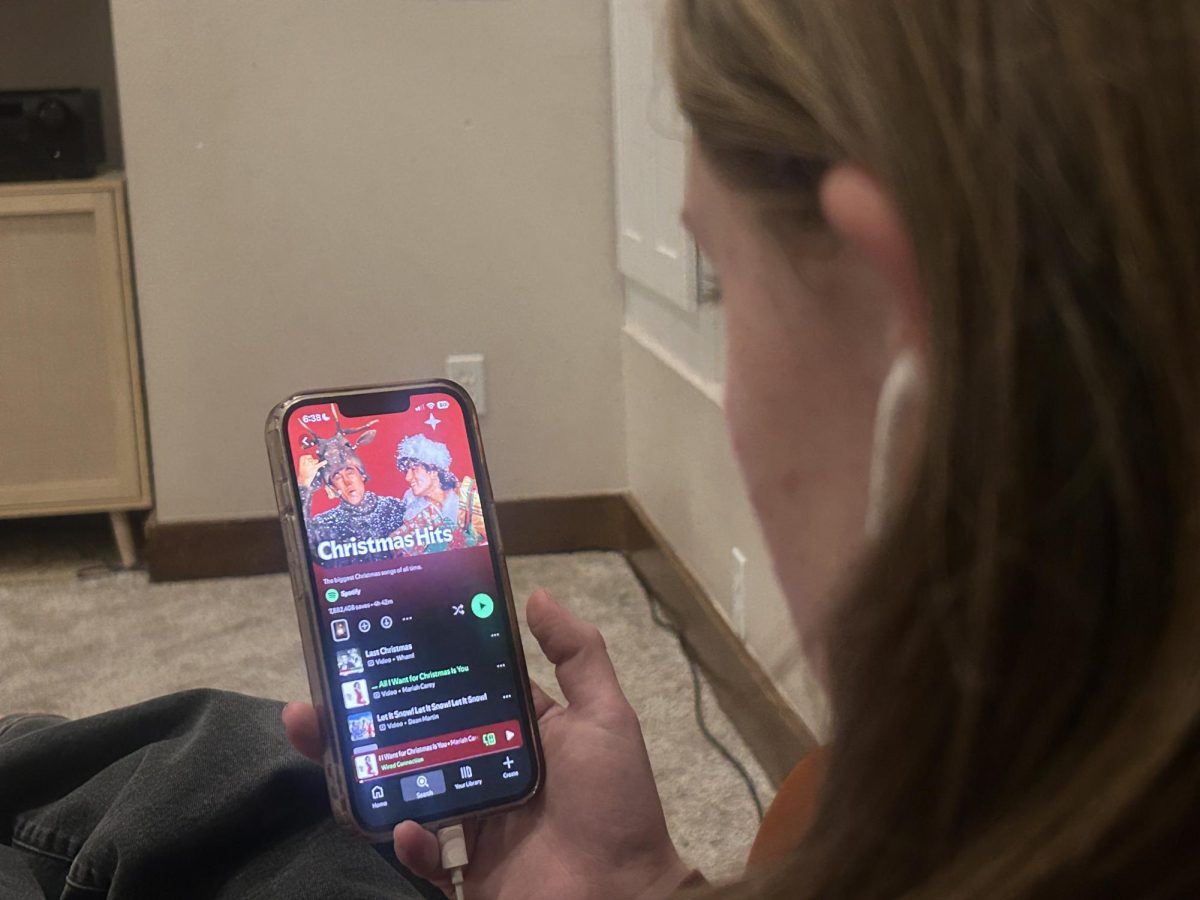 Senior Adelaide Cull checks the newest music for the holiday season. The Holidays are her favorite time of year, and she enjoys spending time with family and friends. 