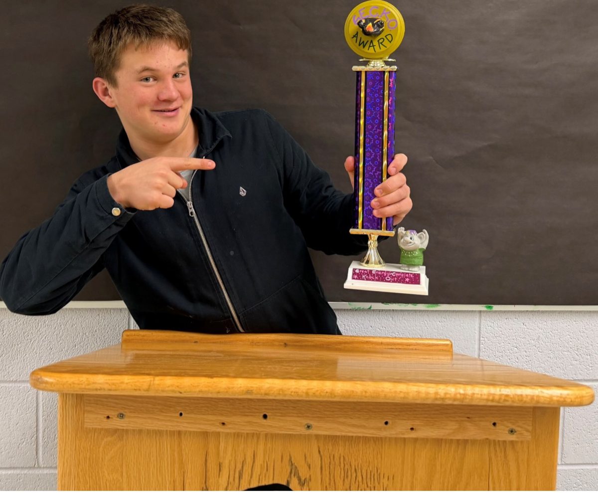 Junior Liam MacGillivary holds up the GECKO award to represent the many celebs awarded at the 68th annual Grammy Awards that took place Feb. 1, 2026, at the Crypto.com Arena in Hollywood. Trevor Noah hosted while other celebs switched off announcing the new awards. Students’ favorite musicians were awarded with over 80 categories of various genres honoring the industry.  