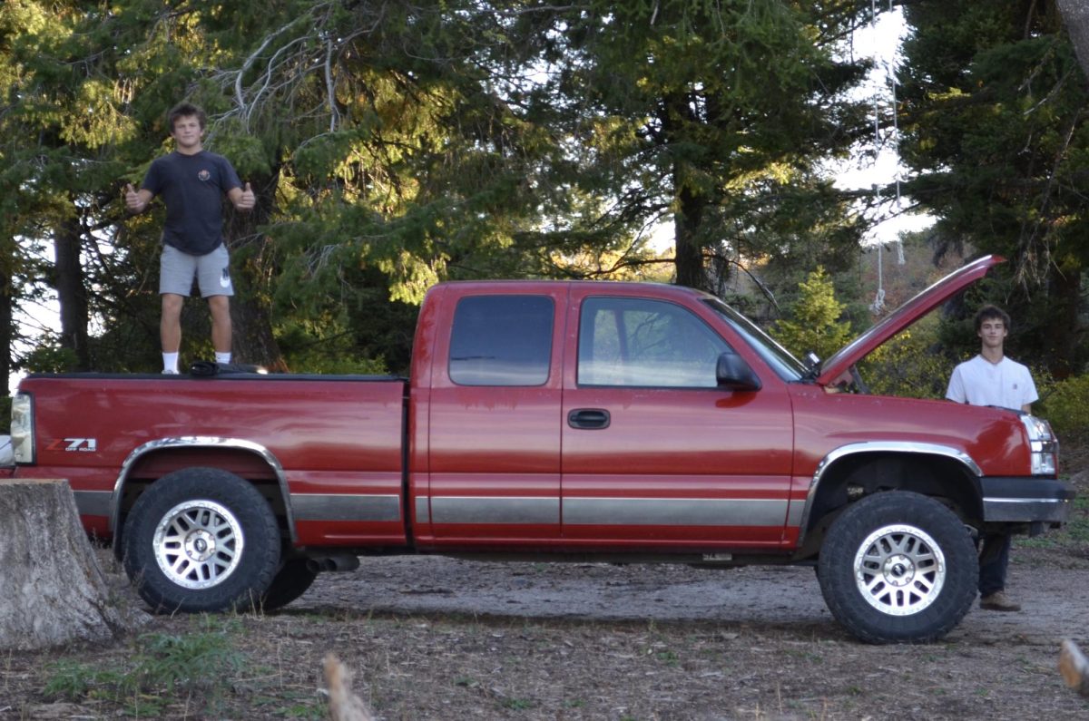 Juniors Liam MacGillivray and Roman Garcia pose with Garcia’s first-generation GM truck. Garcia enjoys cleaning and building up old cars to take them on adventures and give them a second shot on the road.